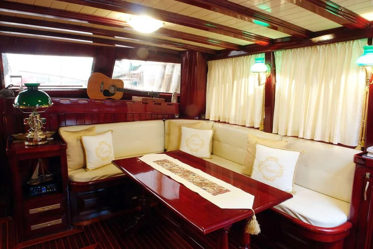 a living room with a bed and a couch aboard ERATO Yacht for Charter