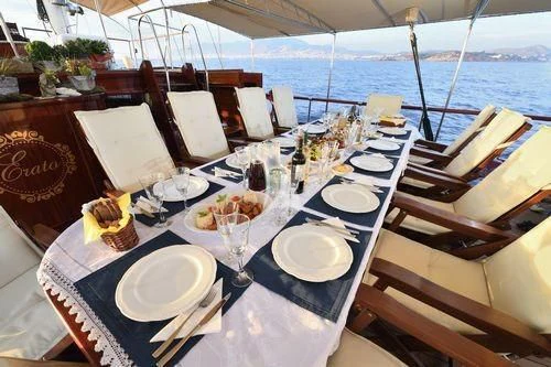 a table with plates and food on it aboard ERATO Yacht for Charter