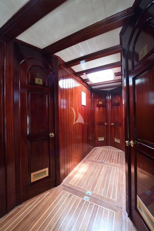 a wood paneled hallway with wooden doors aboard ERATO Yacht for Charter