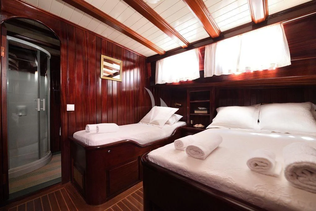 a room with two beds aboard ERATO Yacht for Charter
