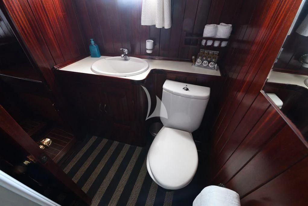 a bathroom with a toilet and sink aboard ERATO Yacht for Charter
