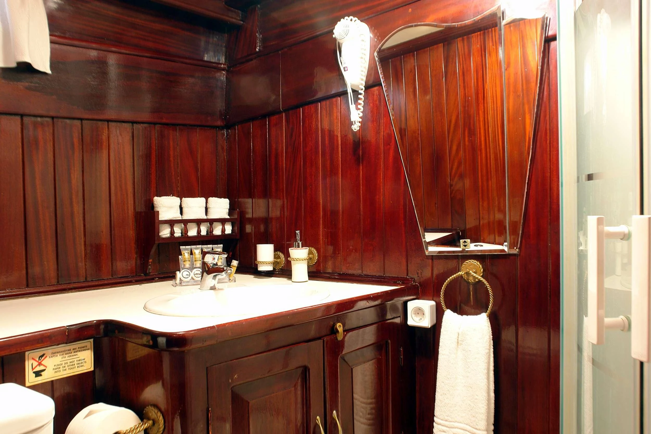 a bathroom with wooden cabinets aboard ERATO Yacht for Charter