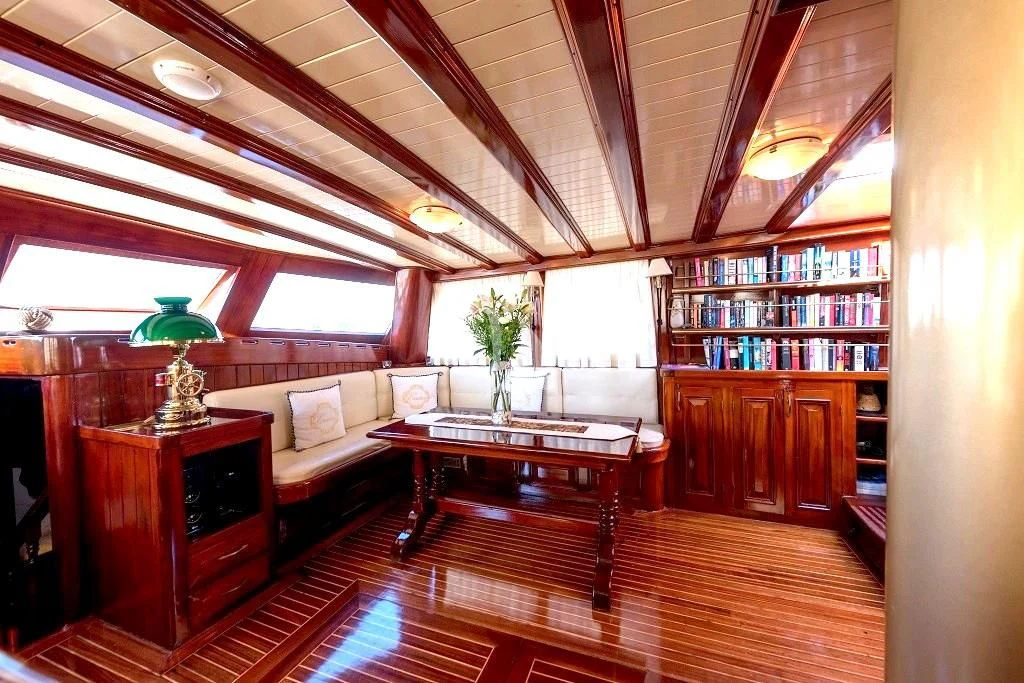 a living room with a table and couches aboard ERATO Yacht for Charter