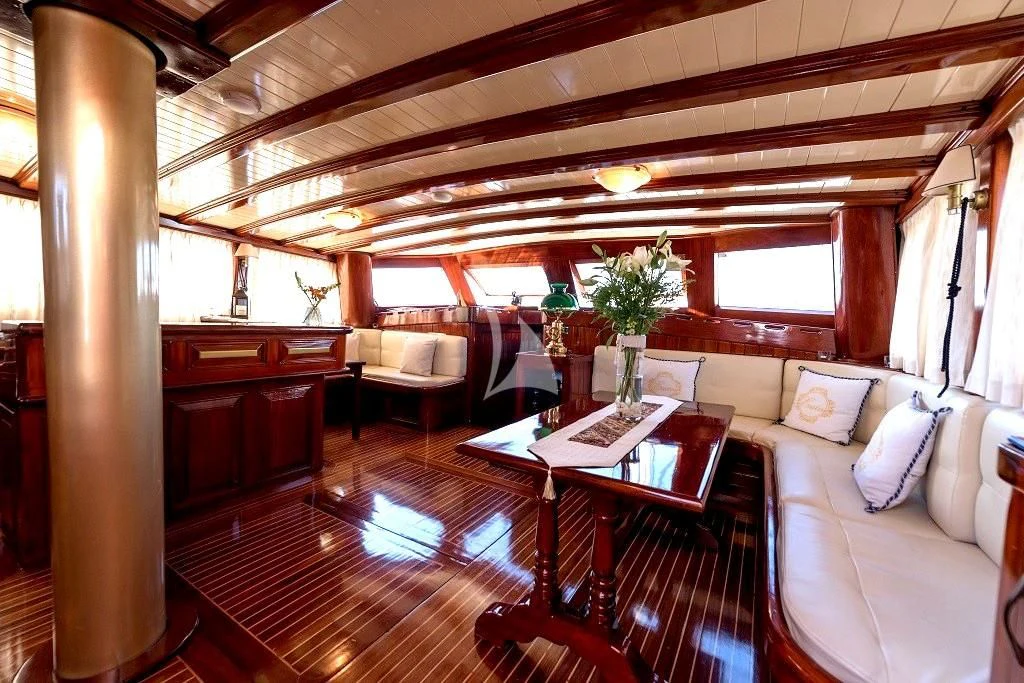 a living room with a table and chairs aboard ERATO Yacht for Charter