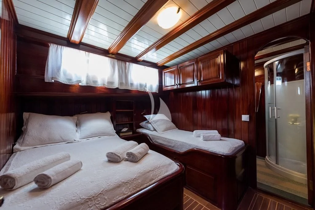 a room with two beds aboard ERATO Yacht for Charter