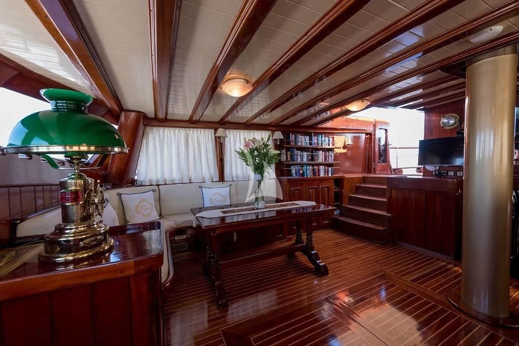 a room with a table and a lamp aboard ERATO Yacht for Charter