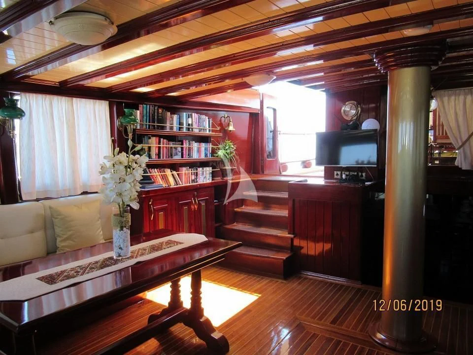 a room with a piano and a piano aboard ERATO Yacht for Charter