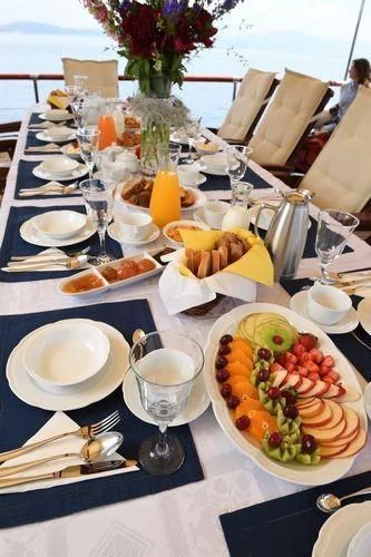 a table with plates and glasses aboard ERATO Yacht for Charter