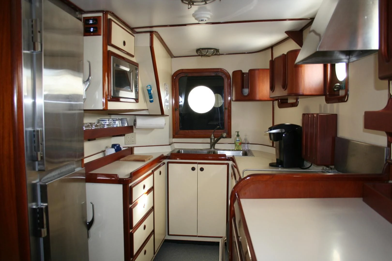 a kitchen with a fridge and a microwave aboard SINDBAD Yacht for Sale