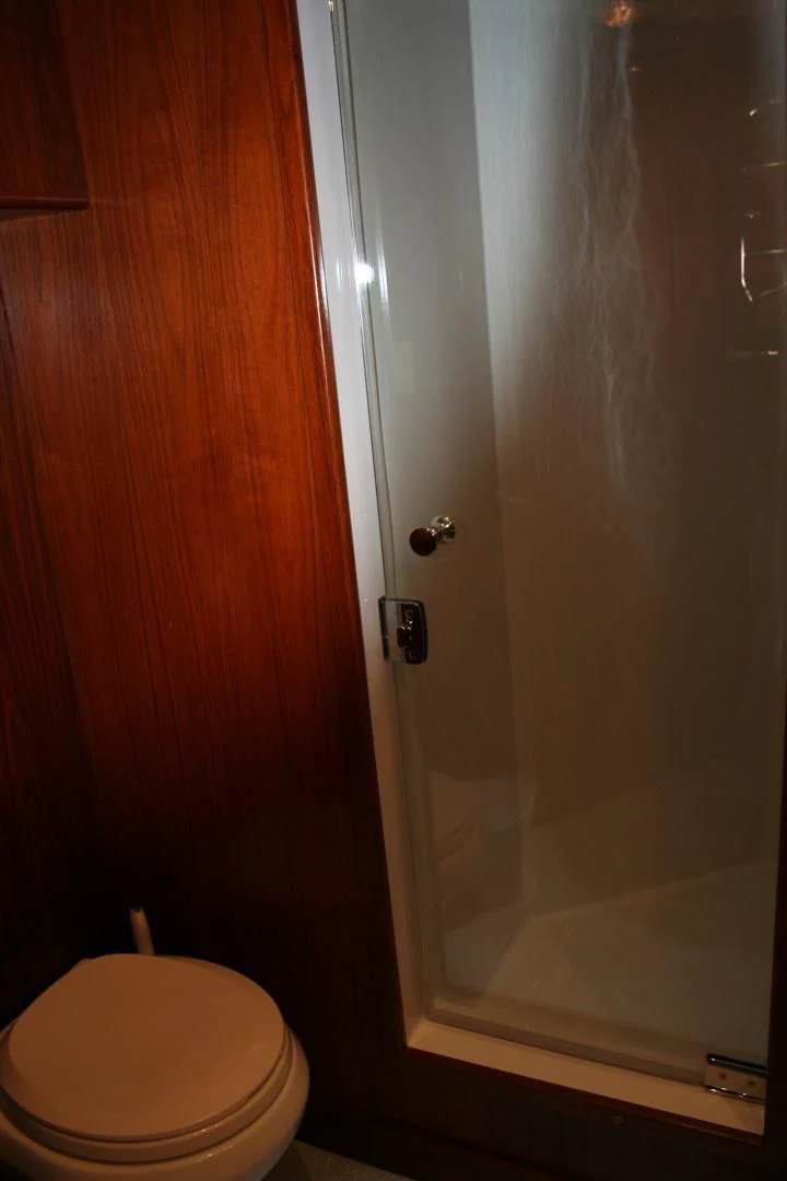 a toilet next to a shower aboard SINDBAD Yacht for Sale