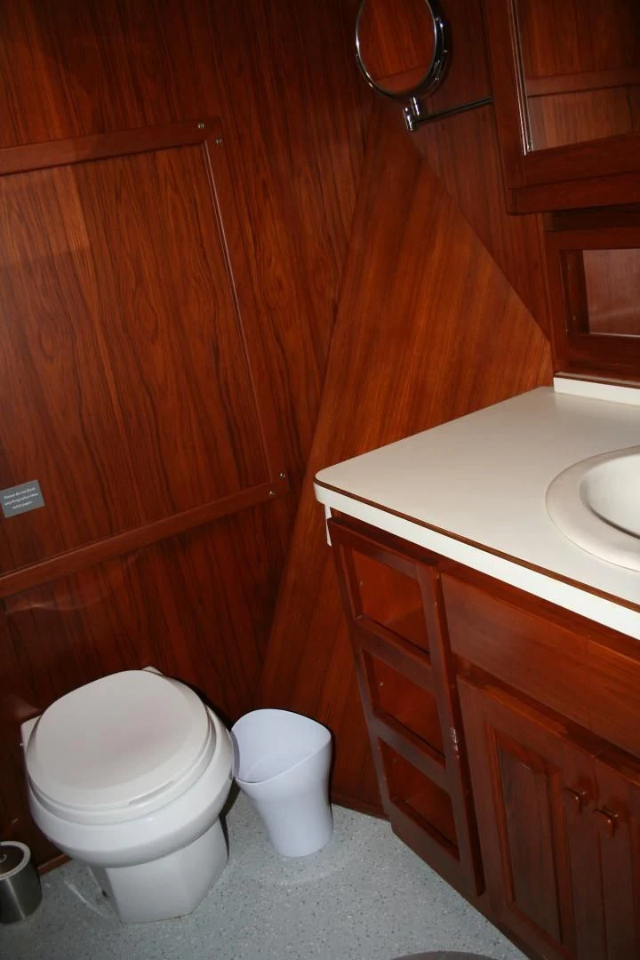 a toilet in a wooden room aboard SINDBAD Yacht for Sale