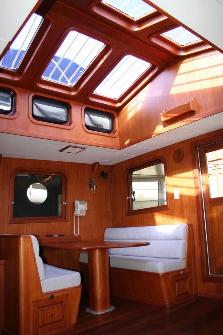 a cabin with a table and chairs aboard SINDBAD Yacht for Sale