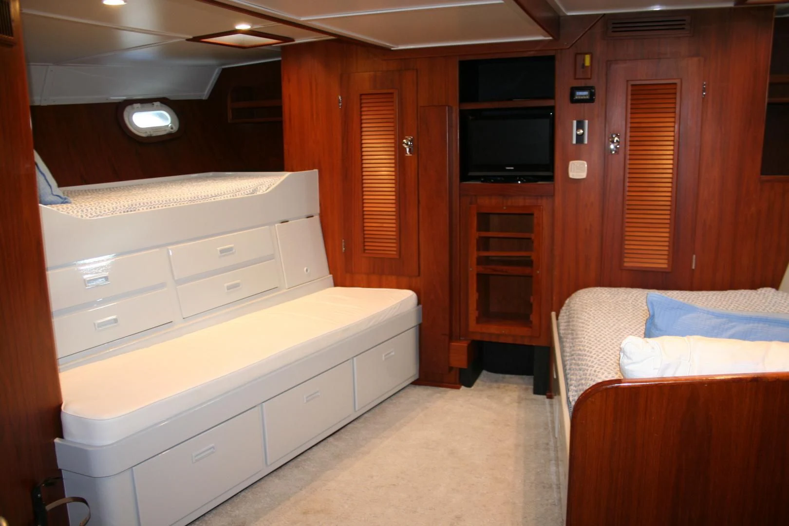 a room with a bed and a television aboard SINDBAD Yacht for Sale
