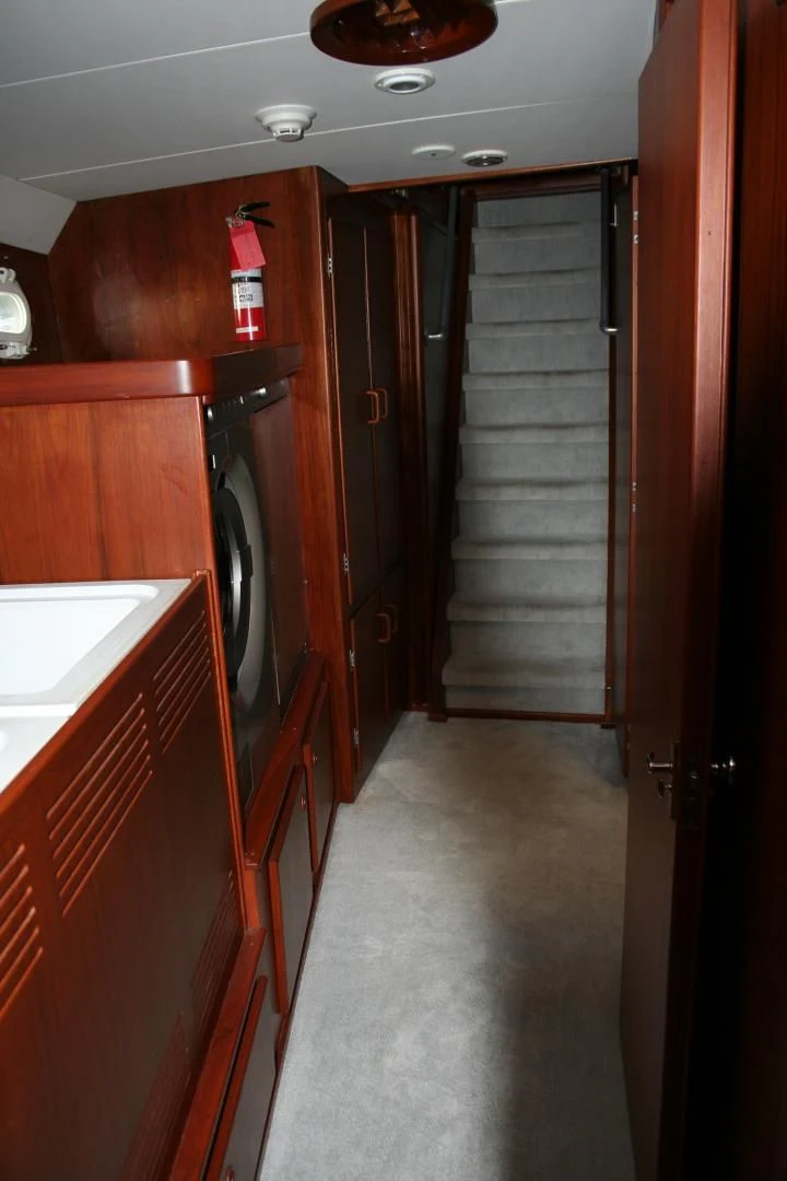 a kitchen with wooden cabinets aboard SINDBAD Yacht for Sale