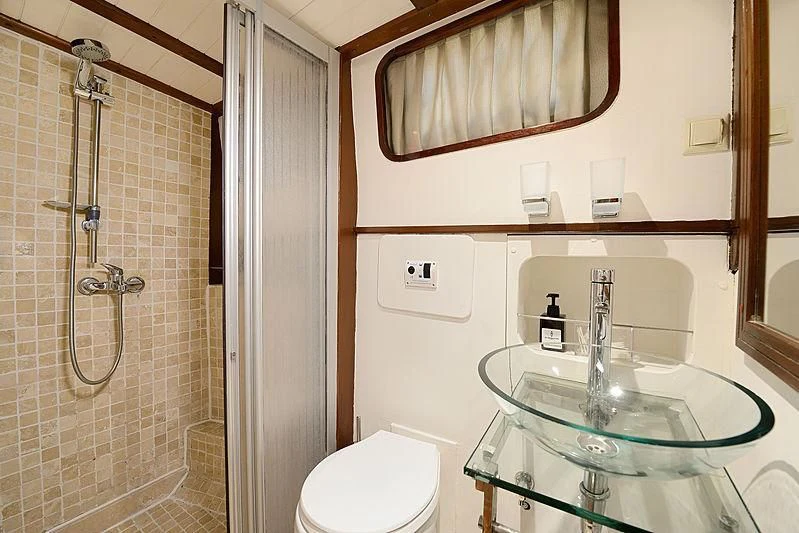 a bathroom with a glass sink aboard COBRA III Yacht for Sale