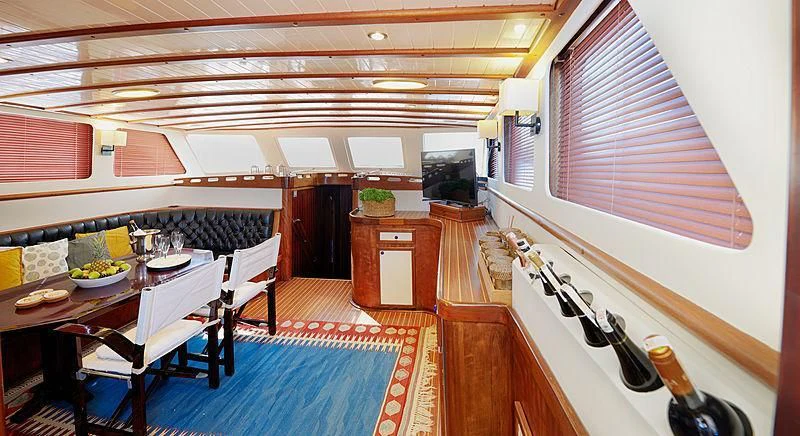 a kitchen with a table and chairs aboard COBRA III Yacht for Sale