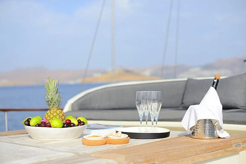 a table with food and a basket aboard COBRA III Yacht for Sale