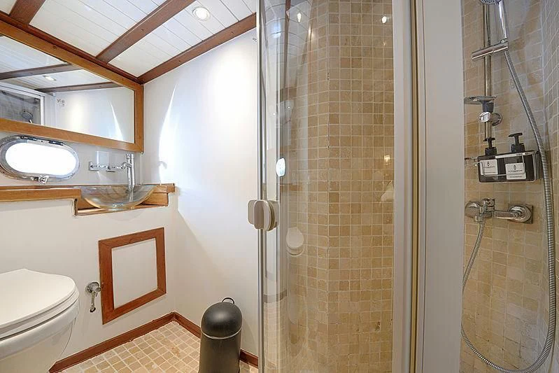 a bathroom with a glass shower aboard COBRA III Yacht for Sale