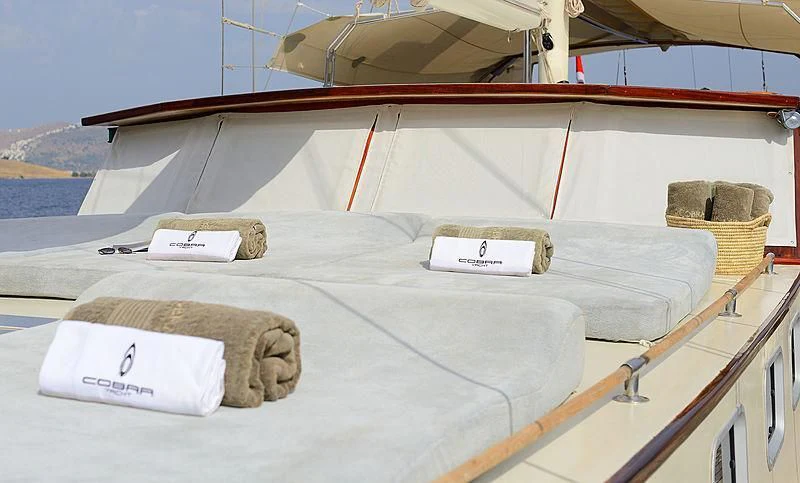 a large white bed on a boat aboard COBRA III Yacht for Sale