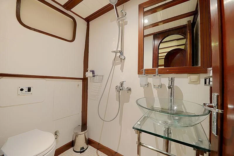a bathroom with a sink and toilet aboard COBRA III Yacht for Sale