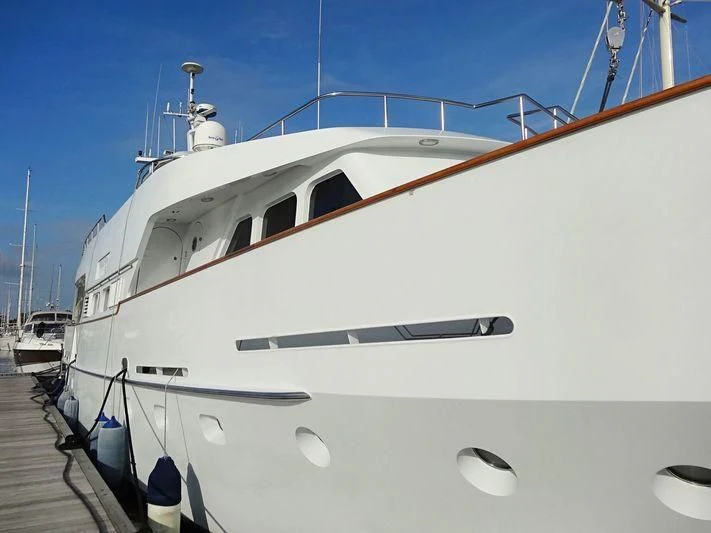 a white boat on a dock aboard SUAKIN Yacht for Sale