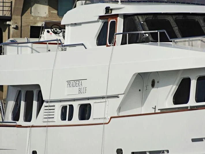 a white yacht in a dock aboard SUAKIN Yacht for Sale