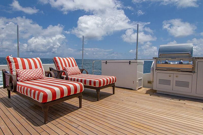 a deck with chairs and a grill aboard SAMARITANA Yacht for Sale