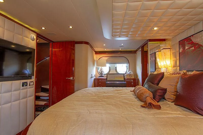 a bedroom with a bed and a piano aboard SAMARITANA Yacht for Sale