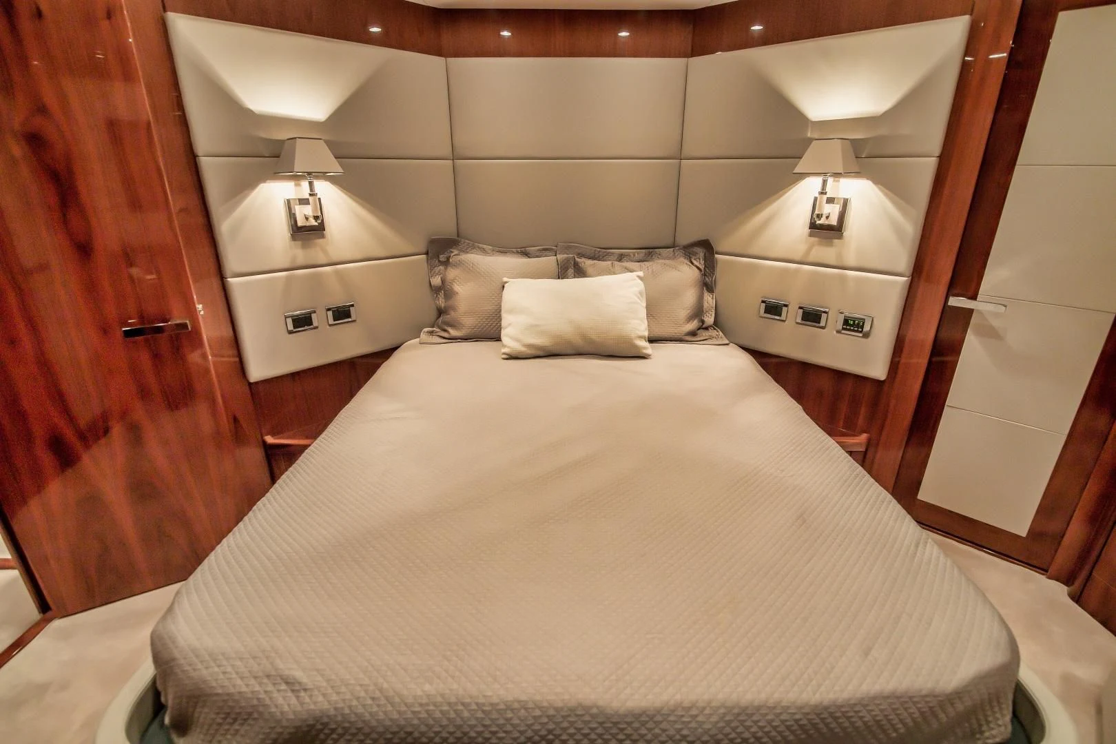 a bed with a white sheet and pillows aboard VIVA LA VIDA Yacht for Sale