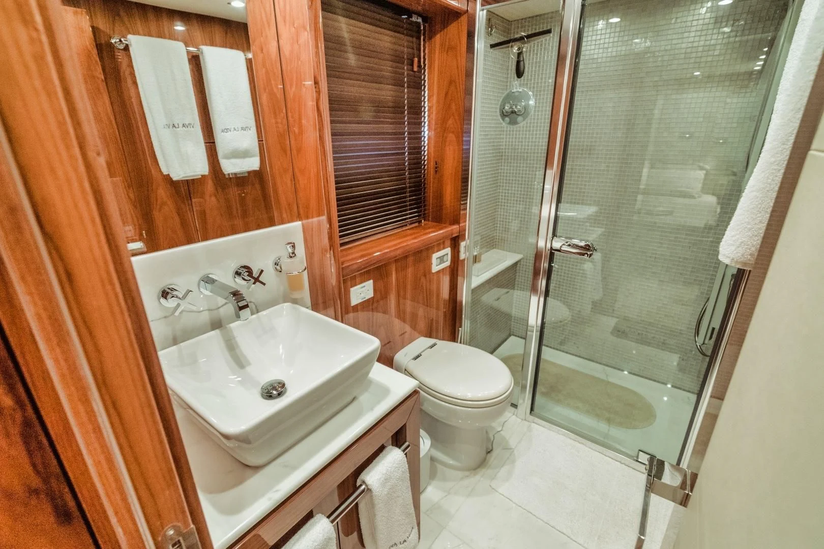 a bathroom with a glass shower door aboard VIVA LA VIDA Yacht for Sale