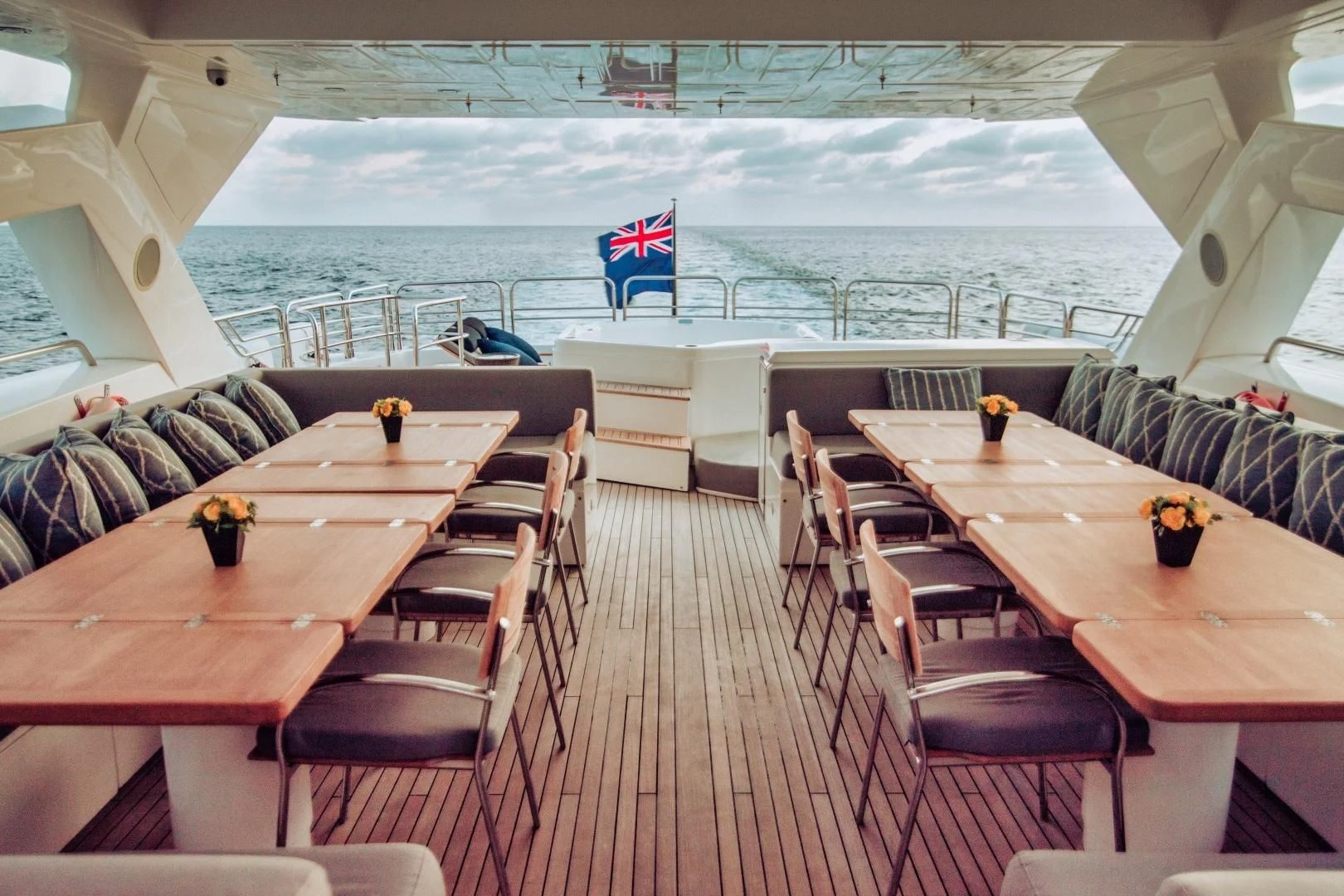 a room with a table chairs and a beach aboard VIVA LA VIDA Yacht for Sale