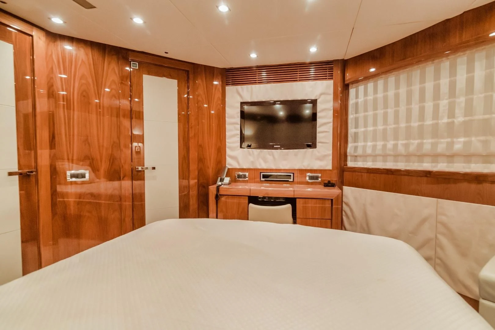 a bed and a television in a room aboard VIVA LA VIDA Yacht for Sale