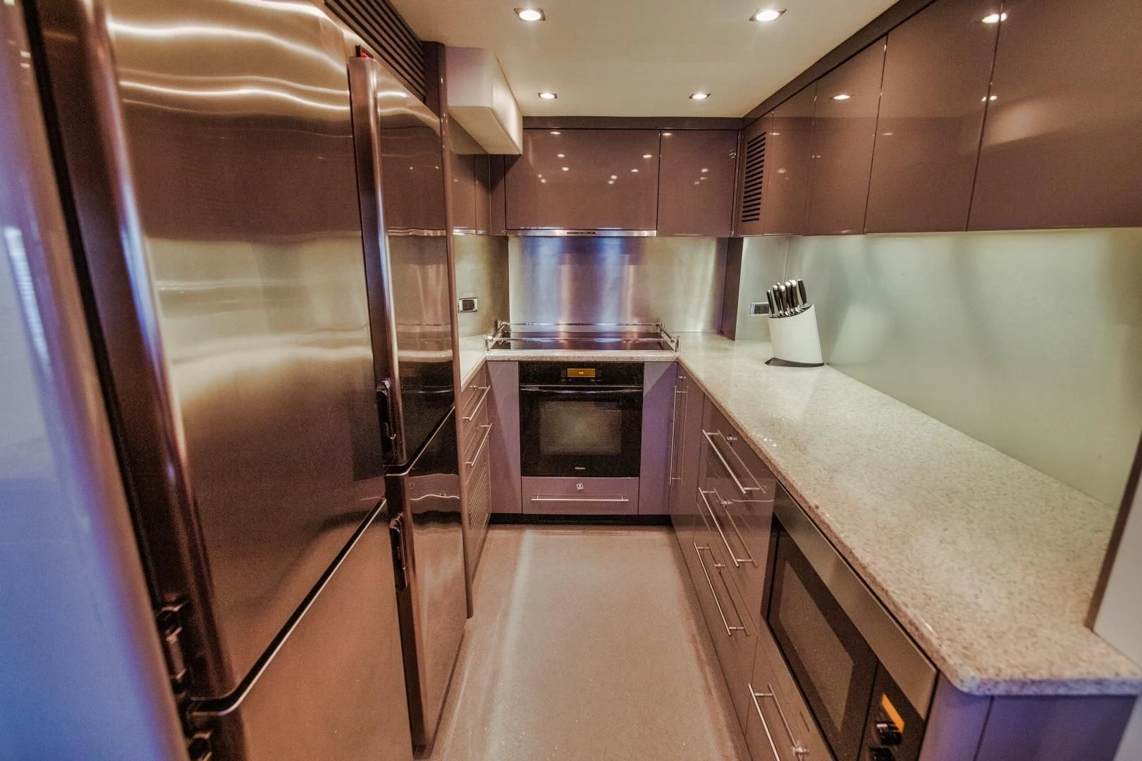 a kitchen with a refrigerator and oven aboard VIVA LA VIDA Yacht for Sale