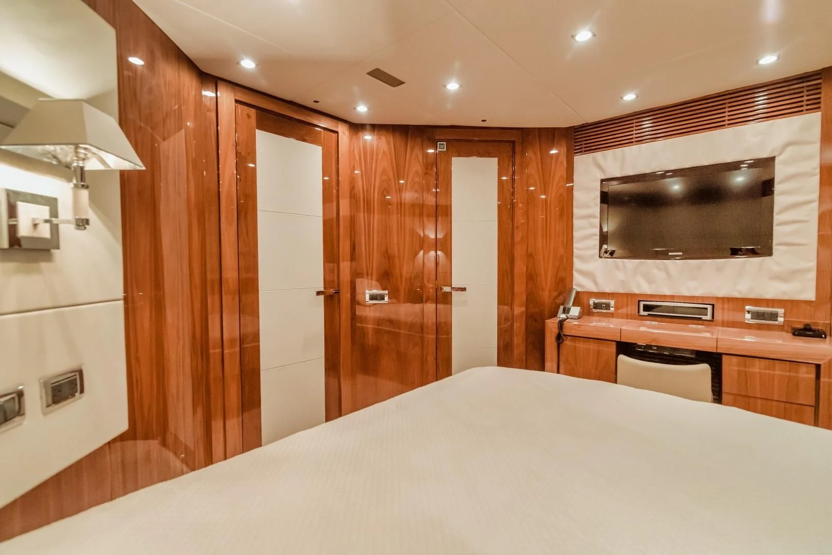 a bedroom with a bed and a television aboard VIVA LA VIDA Yacht for Sale