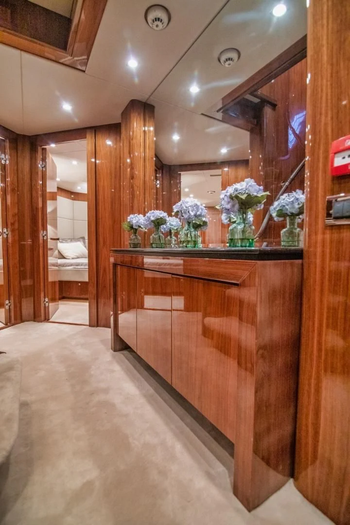 a room with a mirror and a counter with flowers on it aboard VIVA LA VIDA Yacht for Sale