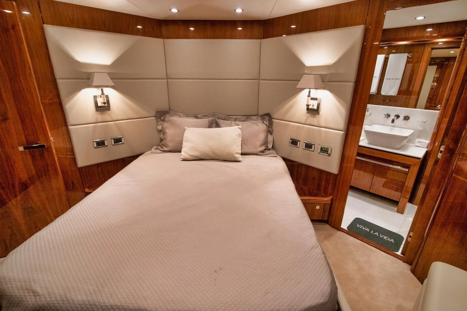 a bed with a white bed spread aboard VIVA LA VIDA Yacht for Sale