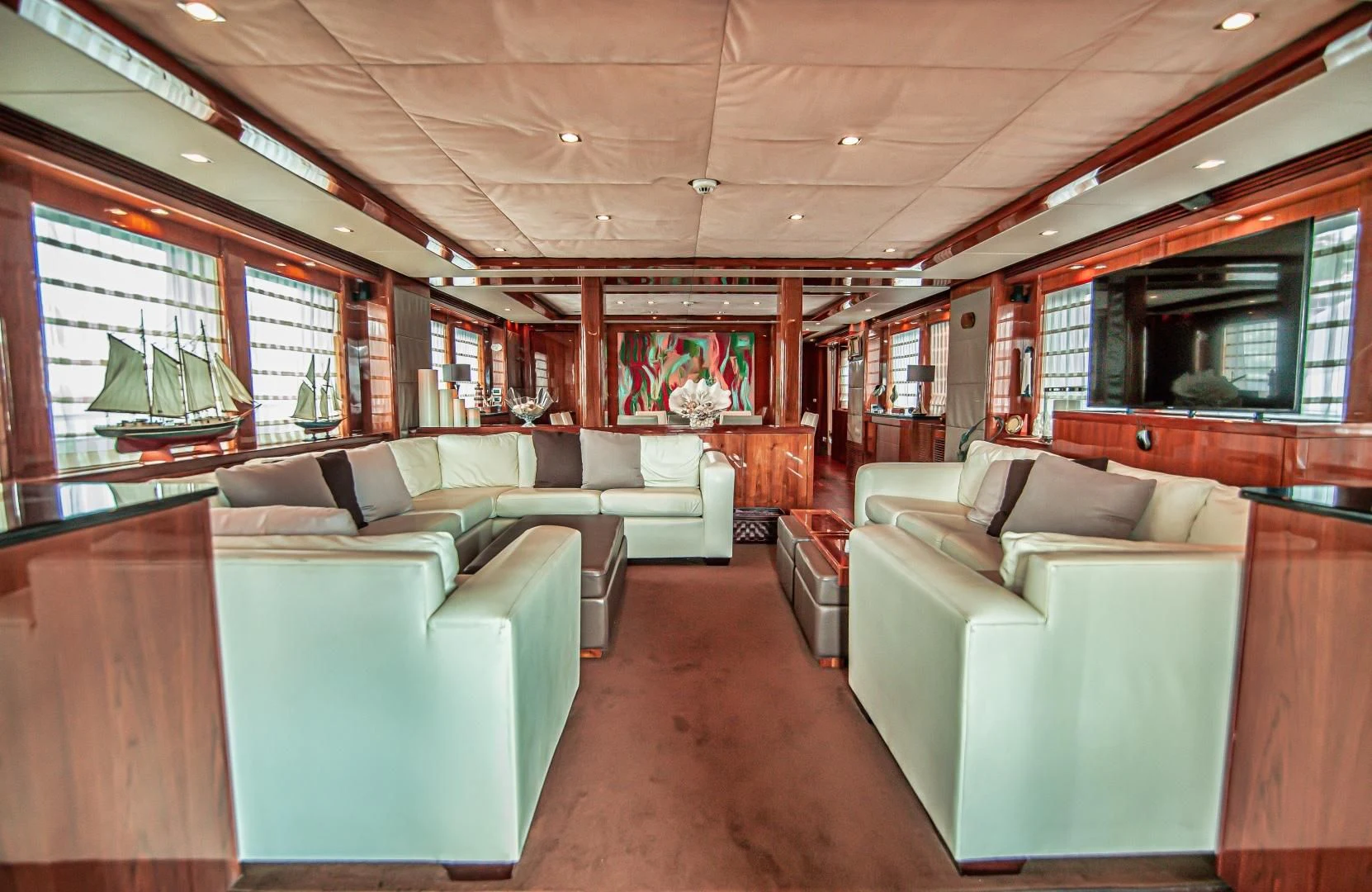 a large room with couches and a table aboard VIVA LA VIDA Yacht for Sale