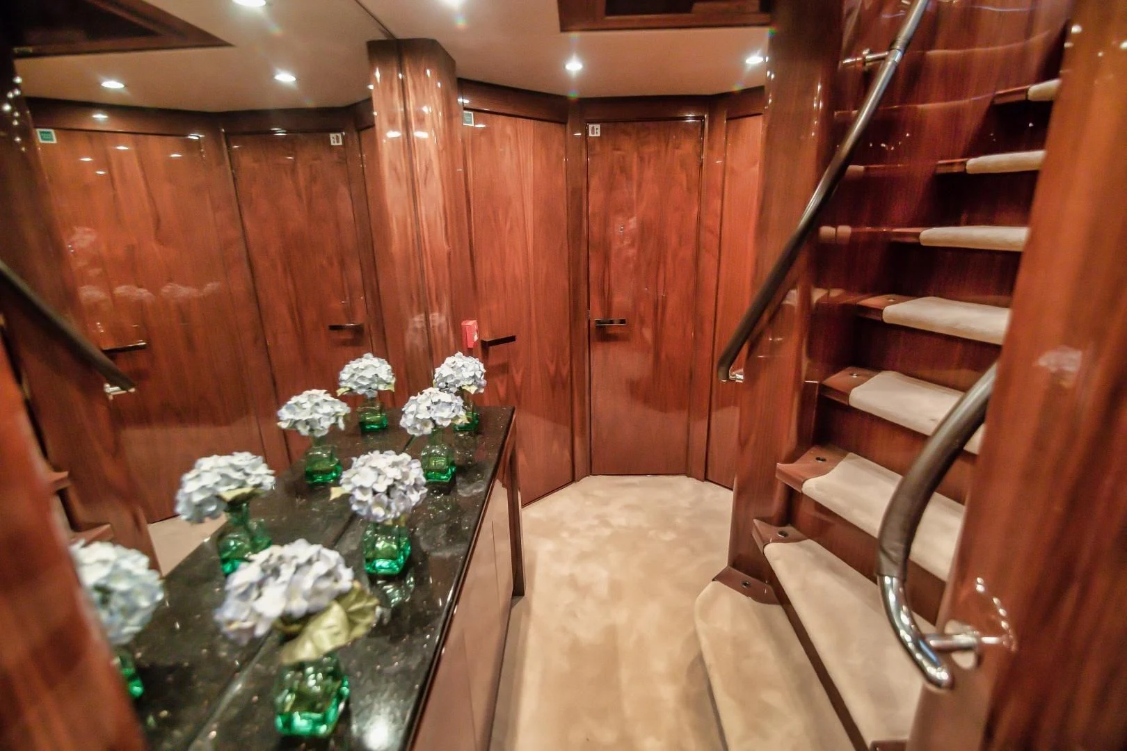 a wooden staircase with flowers aboard VIVA LA VIDA Yacht for Sale