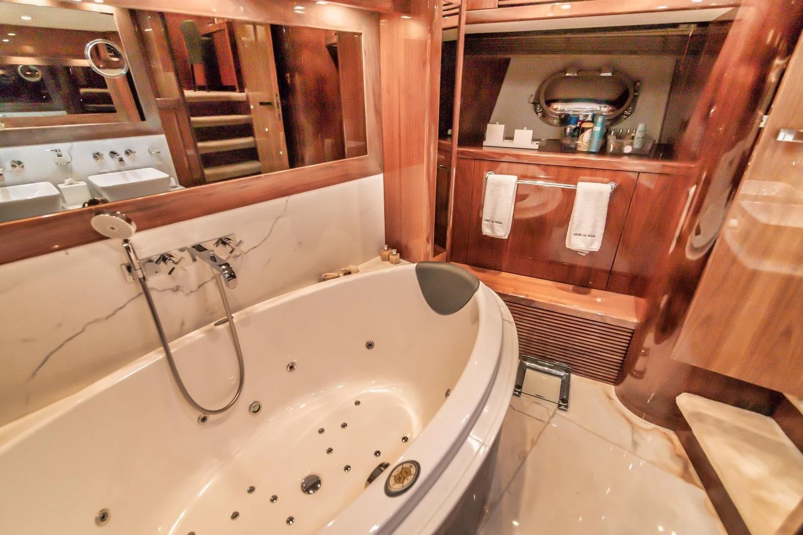 a bathroom with a tub sink and wood cabinets aboard VIVA LA VIDA Yacht for Sale