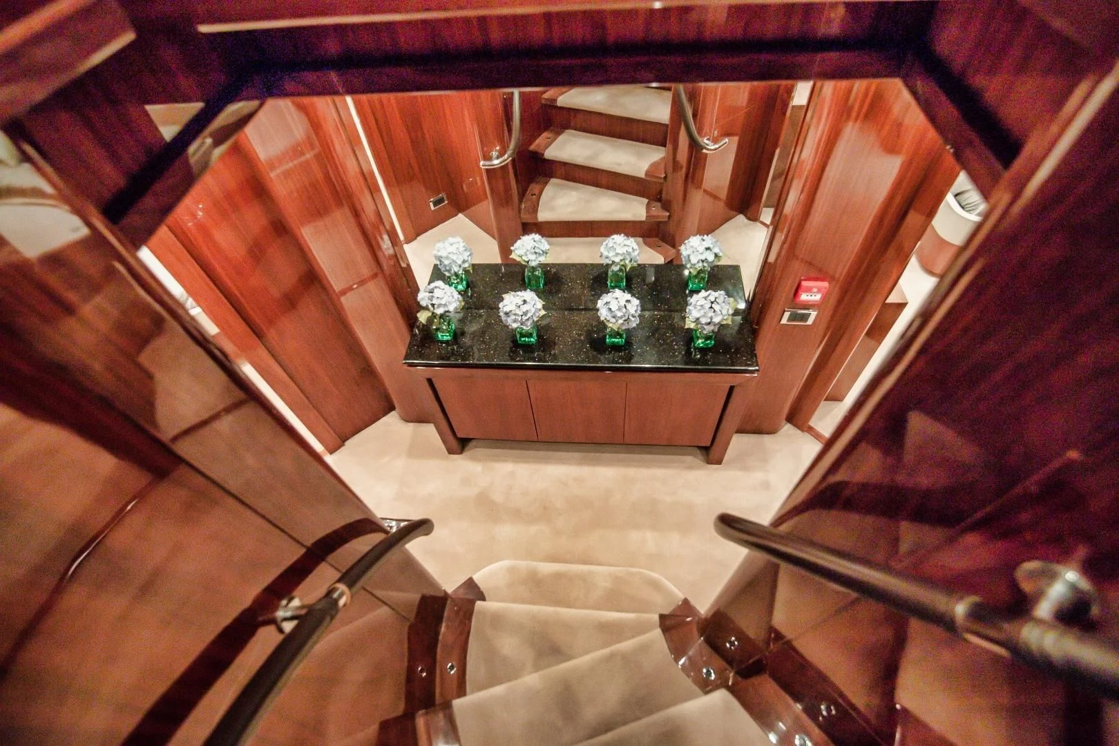 a wooden staircase with a table and chairs aboard VIVA LA VIDA Yacht for Sale