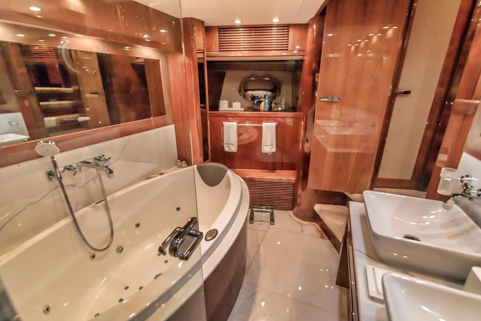 a bathroom with a tub sink and a sink aboard VIVA LA VIDA Yacht for Sale