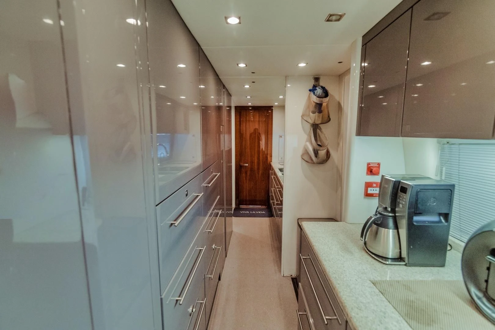 a kitchen with a microwave oven and a refrigerator aboard VIVA LA VIDA Yacht for Sale