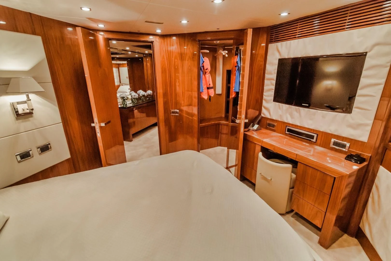 a hotel room with a bed and television aboard VIVA LA VIDA Yacht for Sale
