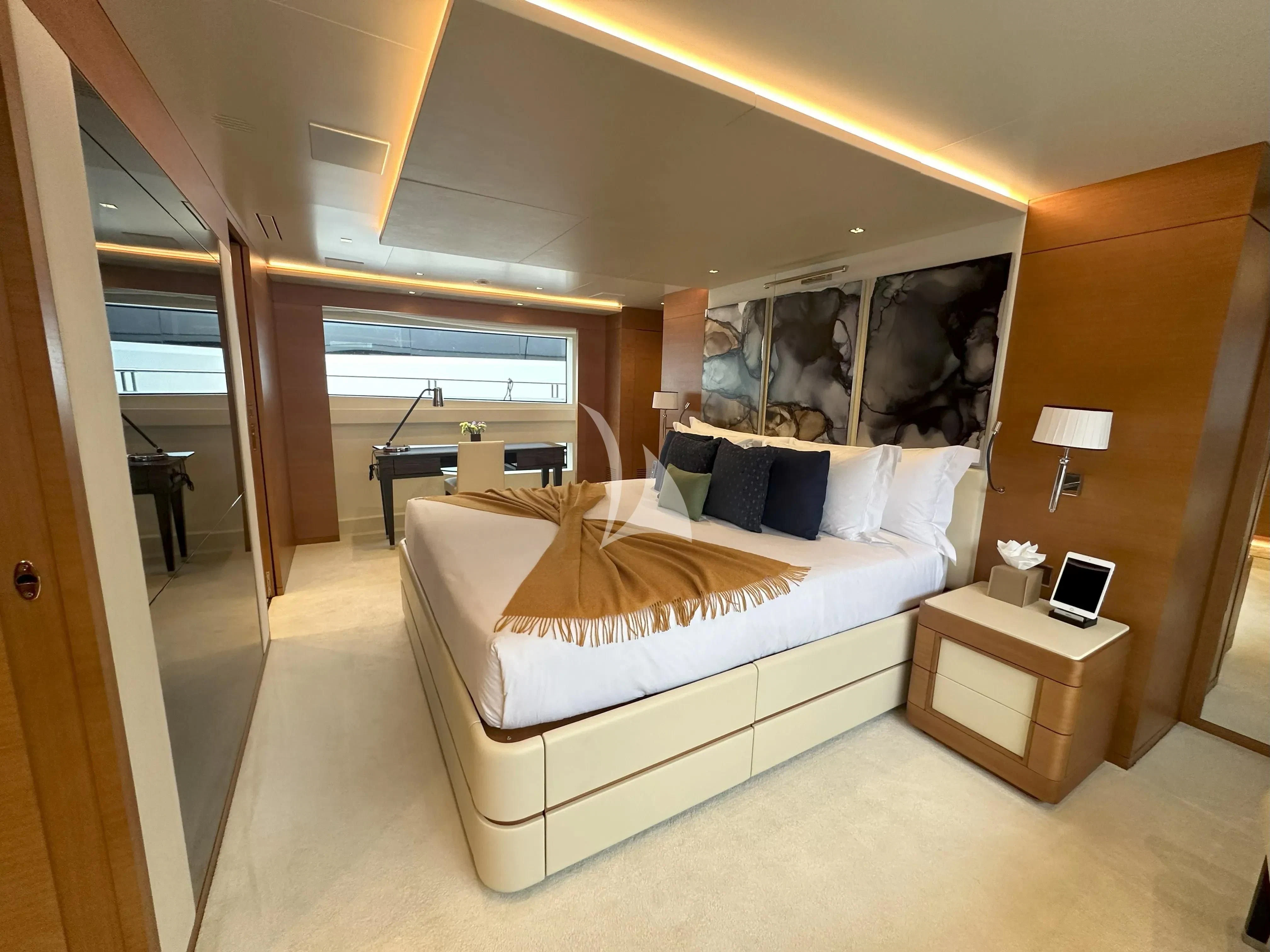 a bedroom with a bed and a desk aboard TONIC BLUE Yacht for Sale