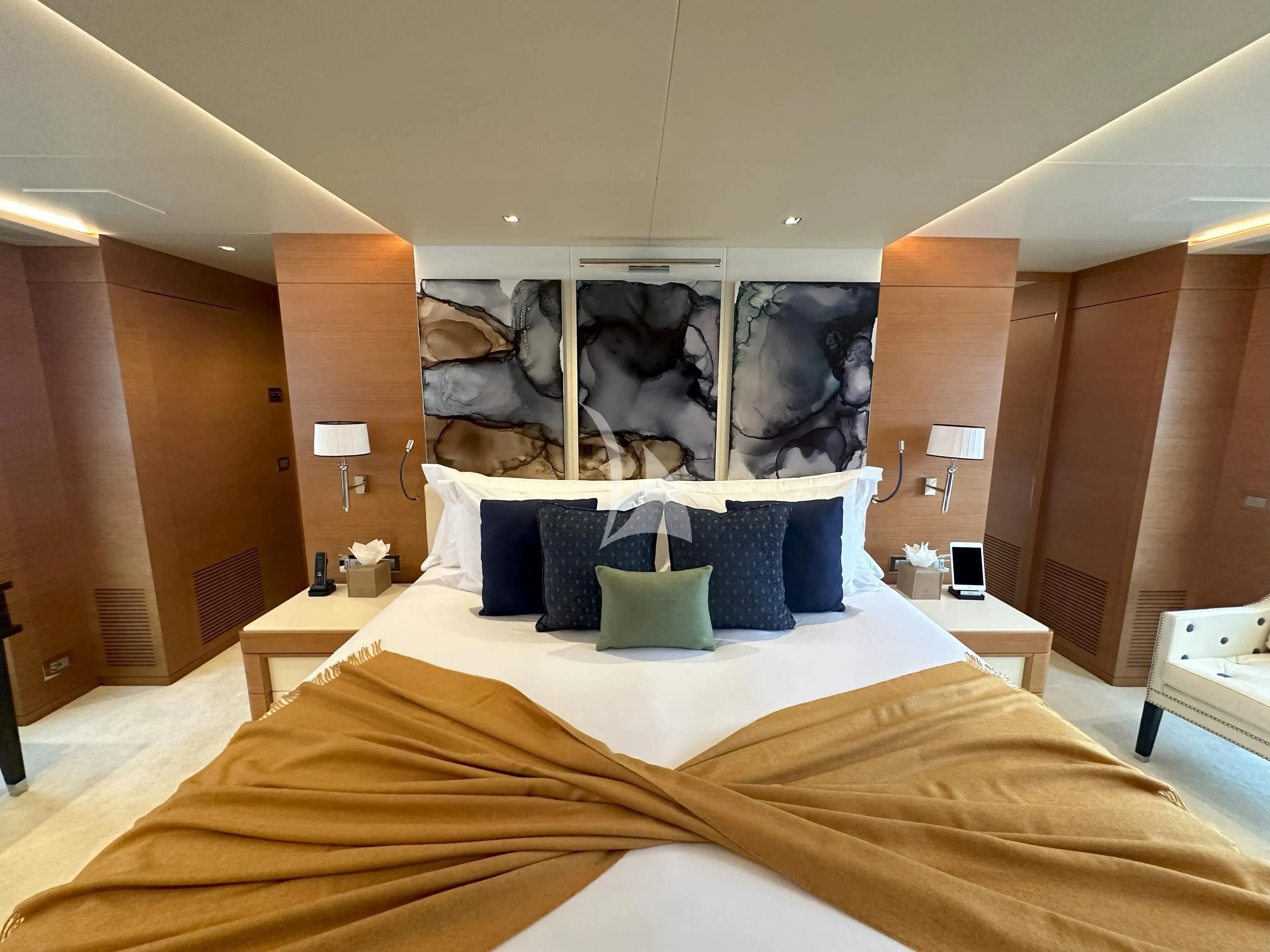 a bed with a white bed spread aboard TONIC BLUE Yacht for Sale
