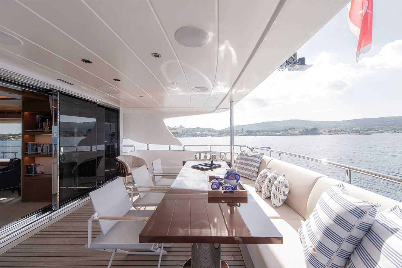 a room with a table chairs and a view of the ocean aboard TONIC BLUE Yacht for Sale