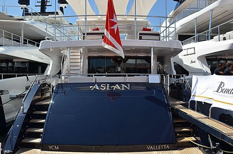 a boat with a flag on the front aboard TONIC BLUE Yacht for Sale