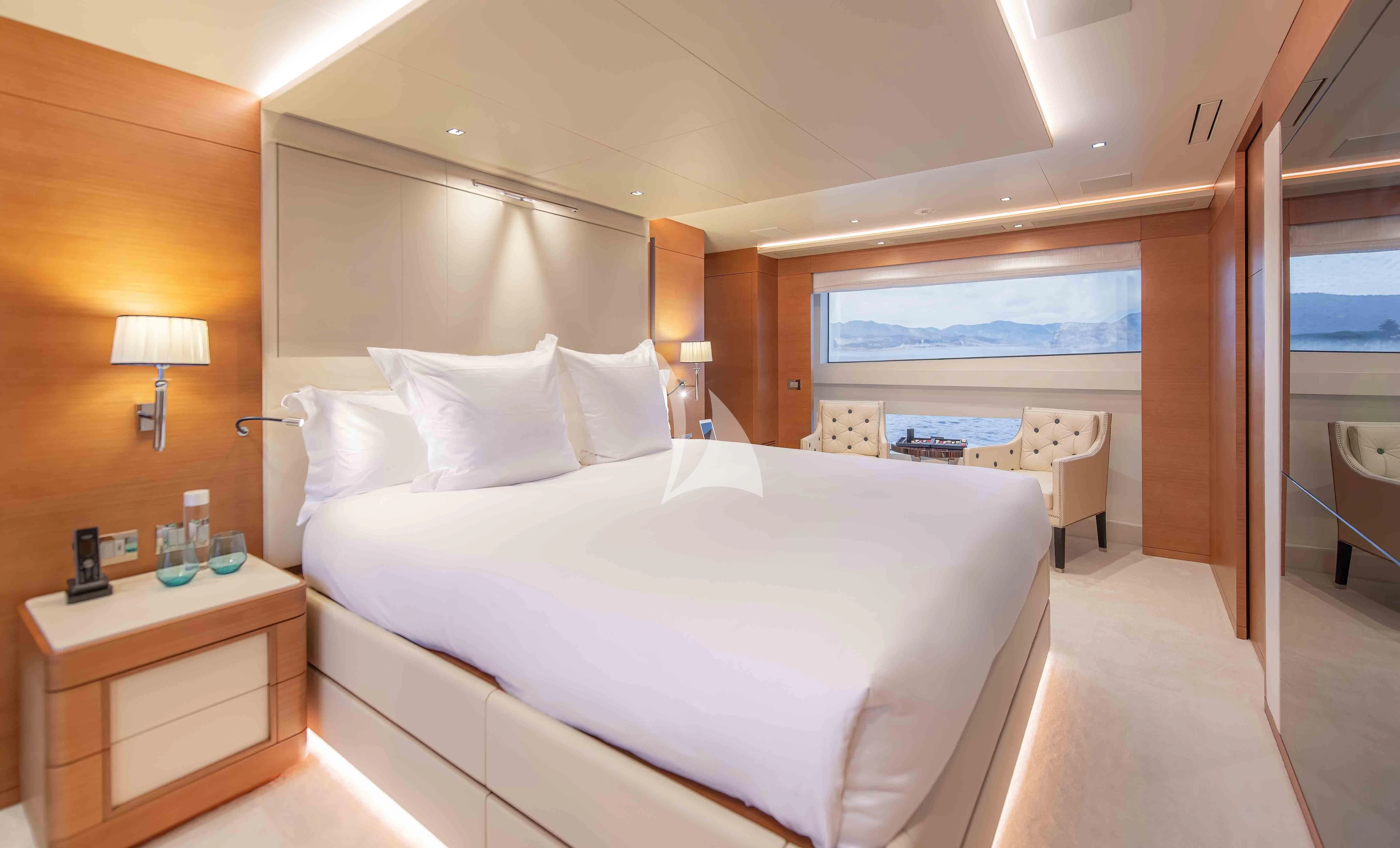 a hotel room with a bed and a table aboard TONIC BLUE Yacht for Sale
