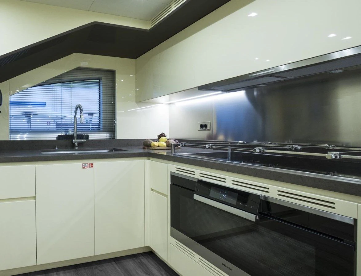 a kitchen with white cabinets aboard TONIC BLUE Yacht for Sale