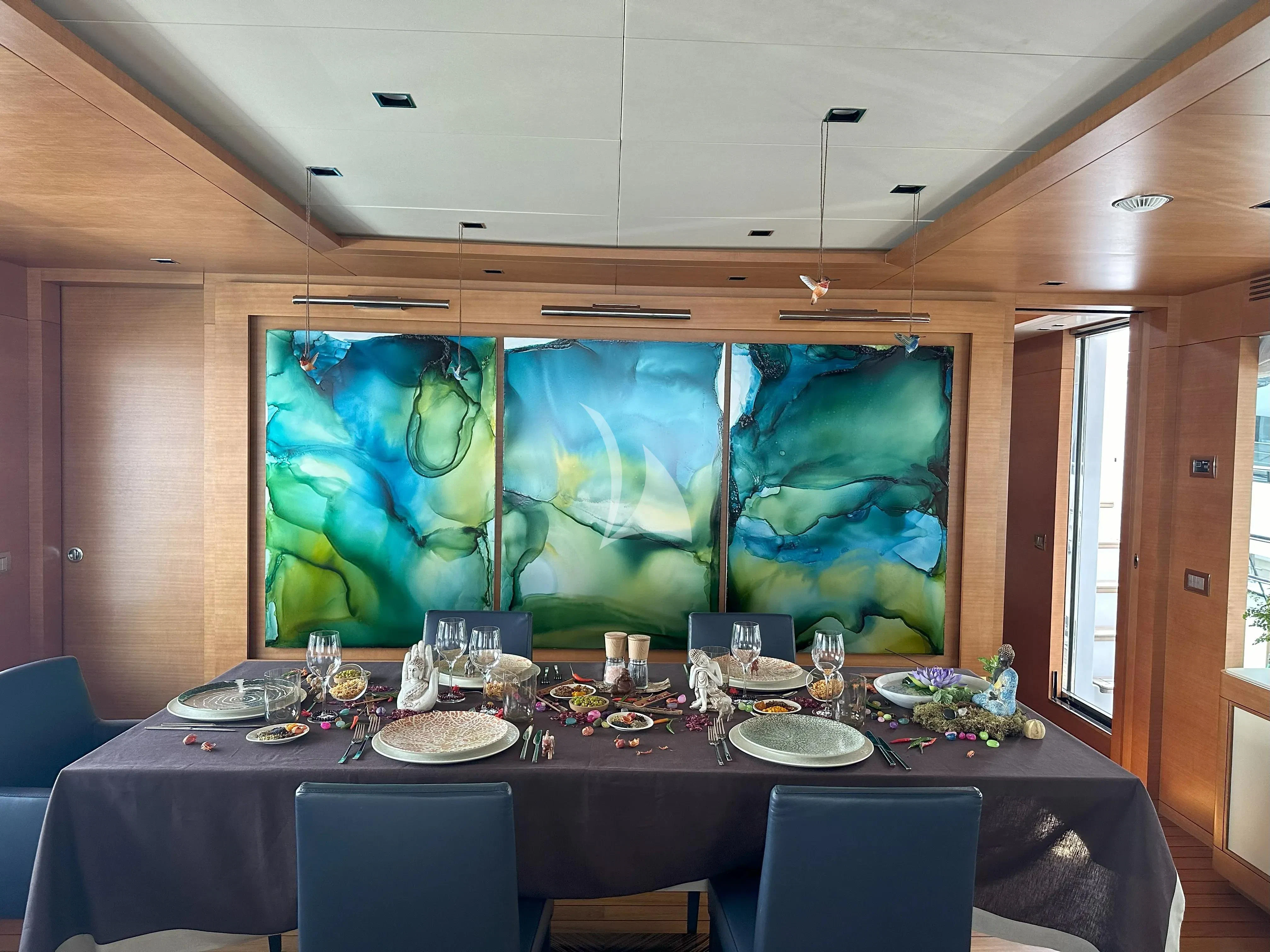 a large table with plates and glasses on it aboard TONIC BLUE Yacht for Sale